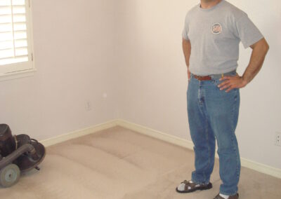 Photo shows client posing with his freshly cleaned carpet